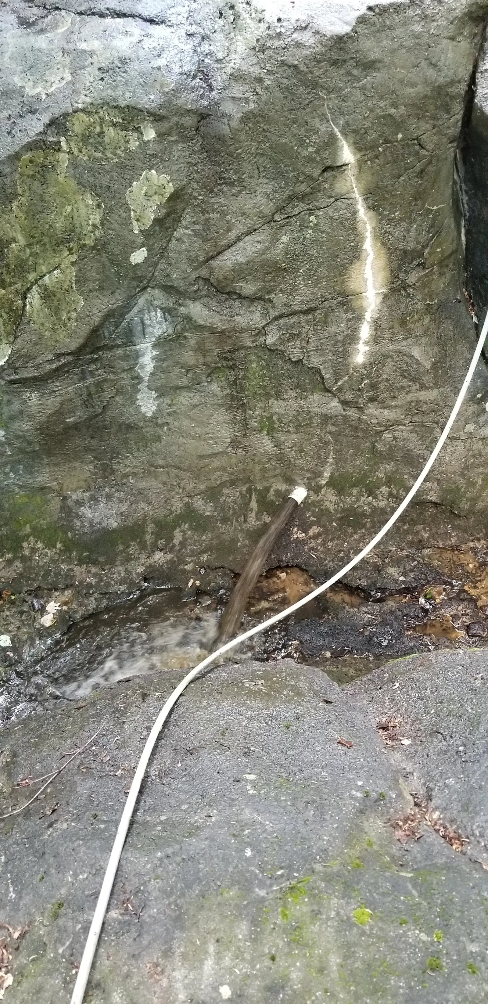 Rock waterfall mid-job, a cleaned streak across stained rock, Townpark Ravine office campus, Kennesaw, Cobb County, GA (May 31, 2019)