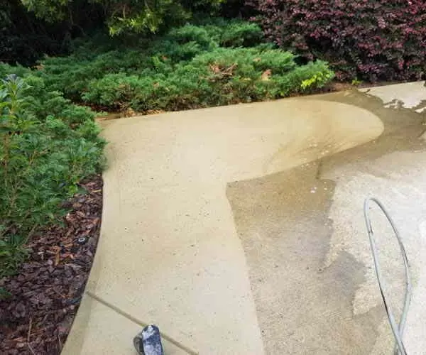 Straight concrete walk beside a house after pressure washing (Oct 2018)
