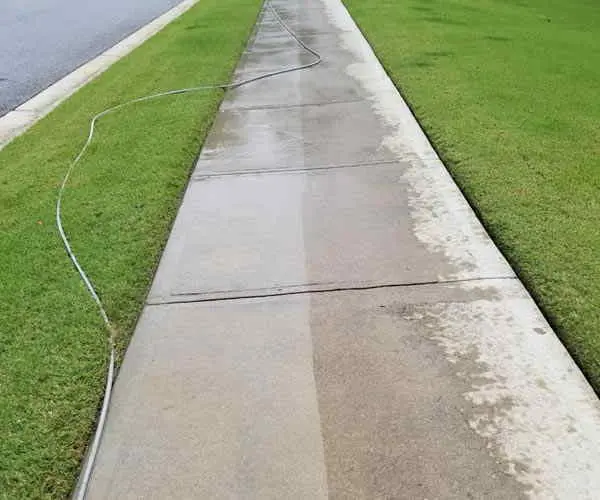 Concrete walk at a garage corner after pressure washing (Oct 2018)
