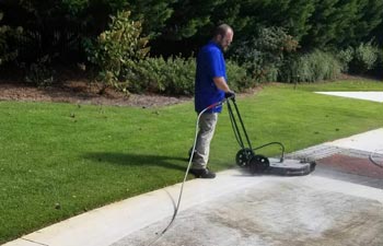 Marietta Pressure Washing worker cleaning concrete paver