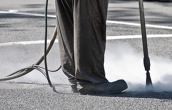 road worker sandblasting on the road